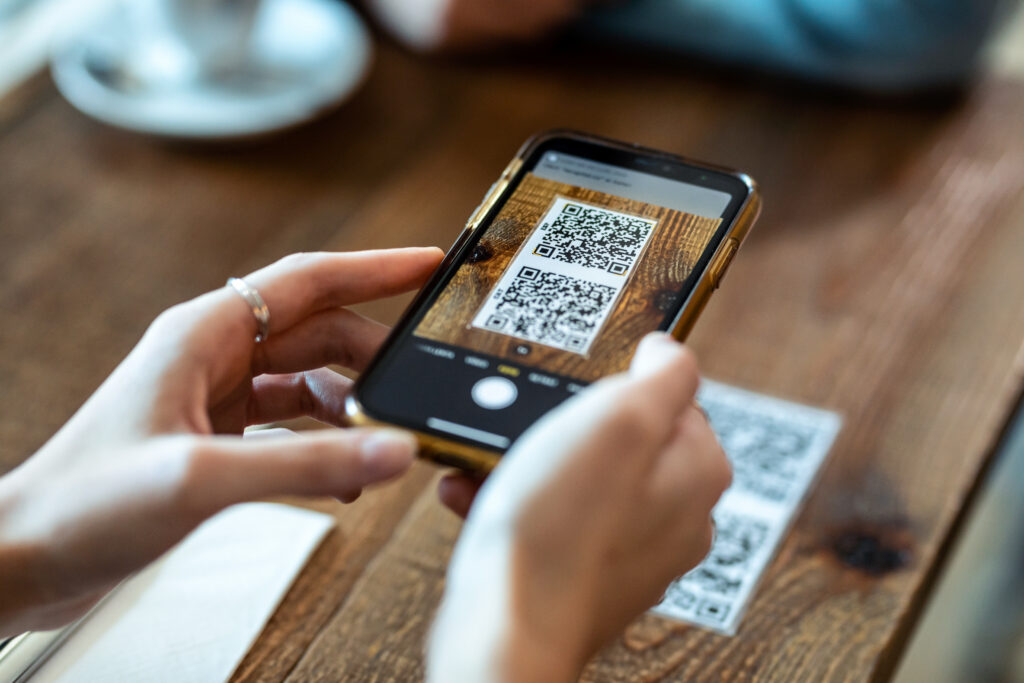 Person using phone to scan QR Code